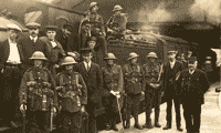 Image shows sepia photograph of soldiers standing beside a steam engine. National Records of Scotland reference GD1/1232/3/4.