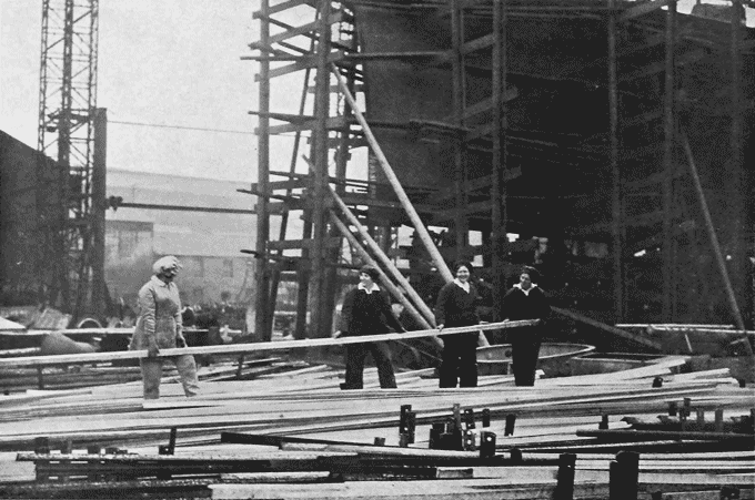 Image of women carrying long steel bars in a shipyard (National Records of Scotland, HH31/27/51/3).